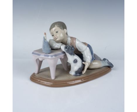 This delicate porcelain figurine by LladrÃƒÂ³, titled Hanukkah Lights  depicts a young boy lighting a menorah with his loyal 