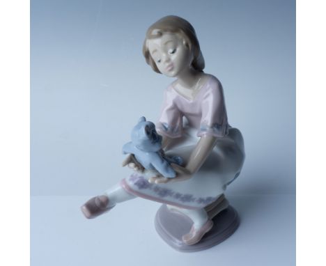 This is a beautifully crafted porcelain figurine titled Best Friend by Lladro. The figurine features a young girl sitting on 