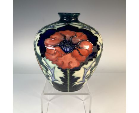 A stunning Moorcroft pottery vase featuring the vibrant poppy design, characterized by its bold red flowers and intricate det