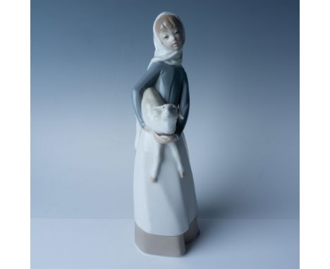 This Lladro porcelain figurine, titled "Girl with Lamb" (number 1004584), measures 11"H and captures a serene moment of a you