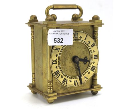 A Smiths brass carriage clock. The dial with Roman numerals, flanked by columns. H11.5cm (excluding handle)