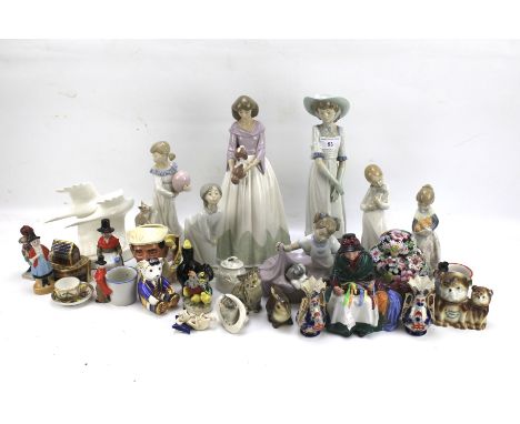 An assortment of ceramics. Including Nao figures, Royal Doulton 'Silks and Ribbons', a pair of Imari vases, Toby jug, etc