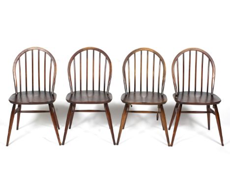 A set of four Ercol dark elm and beech Windsor chairs. With arched spindle backs, on tapering supports and stretchers, H82cm 