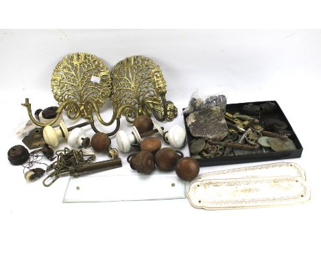 An assortment of metalware. Including a pair of brass light brackets, door knobs, brass hanger, etc