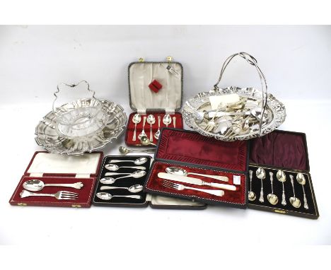 An assortment of silver and silver plate. Including two silver plated fruit baskets, two sets of silver teaspoons, flatware, 