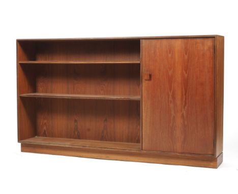 A 1960s Gplan teak bookcase. With three shelves flanked by a cupboard with wooden square handle enclosing a single shelf, on 