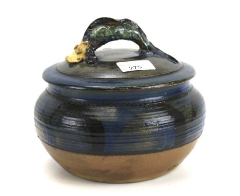 A 20th century studio pottery lidded pot. The handle in the form of a stylised fish, stamped mark to underside 'R' 20cm diam.