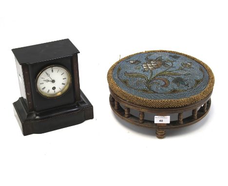 A contemporary wooden mantle clock and a Urquhart &amp; Adamson footstool. The clock with a white dial with Roman numerals, r