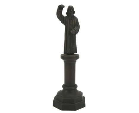 A bronze figure of John Wesley. Modelled as standing on a column with an octagonal base, H19cm