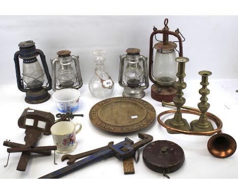 An assortment of collectables. Including a decanter, two lamps and a brass candlestick