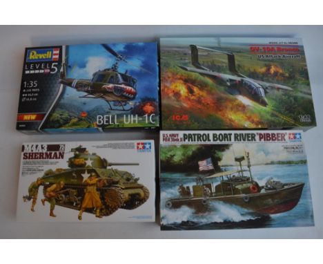 Four unstarted plastic model kits, WWII/Vietnam War themed to include a 1/35 scale Tamiya M4A3 Sherman tank, 1/35 Revell Bell