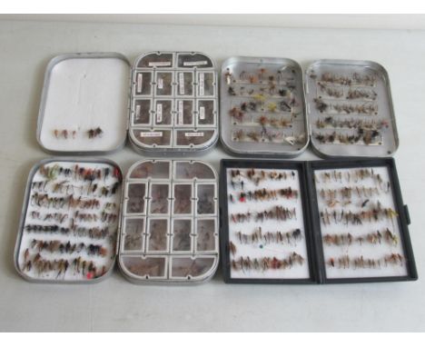 Three metal cases and one plastic case of hand-tied fly fishing lures of various styles and materials