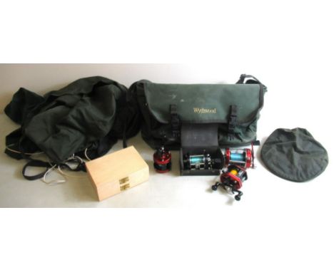 Assortment of fishing tackle and related equipment, including four reels, fly boxes, fly tying materials, metal fly cases, a 