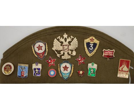 Soviet Russian Army forage cap mounted with three insignia patches and fifteen enamelled badges. P&amp;P Group 1 (£14+VAT for