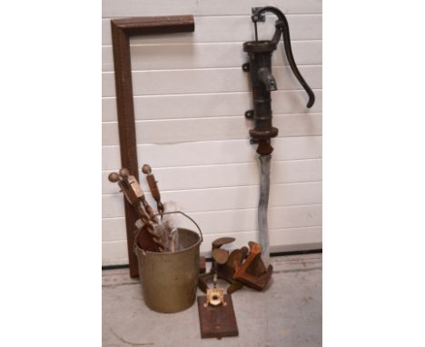 An ebonised water pump, a weathered fire fender and further metalware and tools to include a cream-painted grinder prepared f