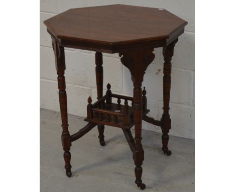 A 19th century octagonal mahogany table with carved and turned supports, lower gallery shelf and stretchers (af), diameter 51