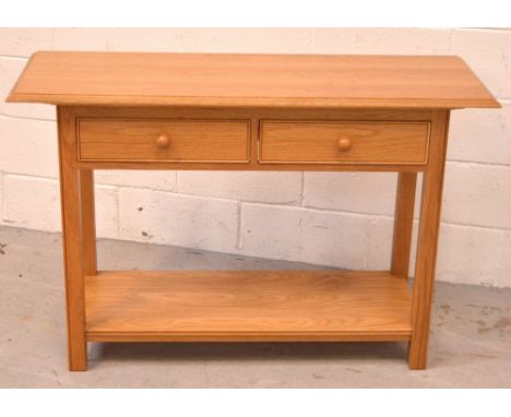 A 20th century oak hall table with two small drawers over lower shelf, length 115cm, depth 41cm.