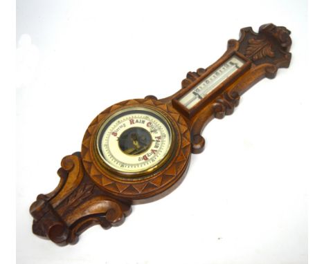 A carved oak wall barometer, height 61cm.