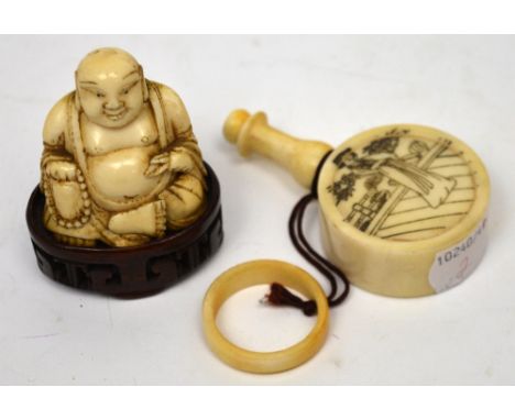 A Japanese ivory figurine of a Buddha and a bone perfume flask with ink decoration of geisha girls (2).