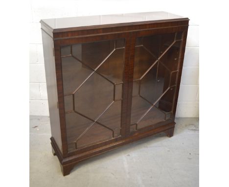 A mahogany twin-door astragal glazed display cabinet on bracket feet, width 107cm.