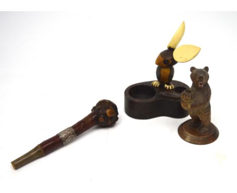 A carved Black Forest style bear raised on stepped rounded base, 13cm, a knopped handle from a parasol or walking stick with 