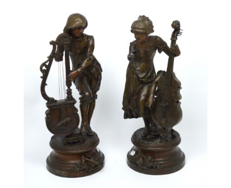 A late 19th century pair of bronzed spelter figurines of musicians, a young lady playing a double bass and a young man playin