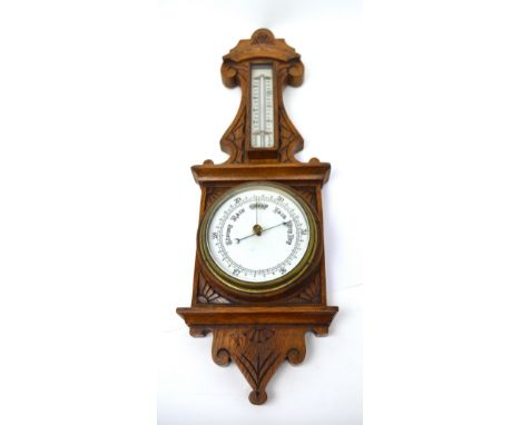A carved oak-cased wall barometer, height 58cm.