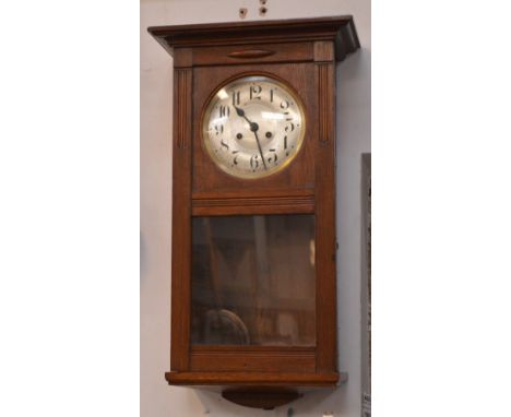 An oak-cased wall clock, silvered dial set with Arabic numerals and a mahogany standard lamp (2).