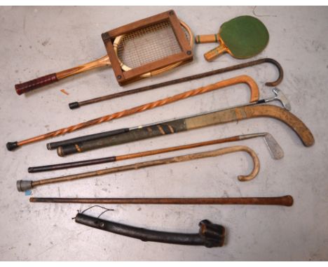 A shillelagh, a small quantity of walking sticks and sporting items to include a vintage tennis racket and an A G Wood Wirral