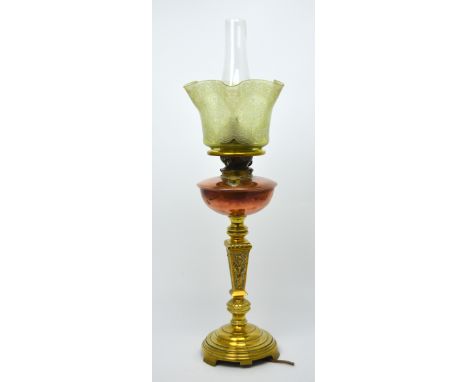 A Duplex brass and copper oil lamp with tinted green glass shade, converted to electricity, height 70cm.