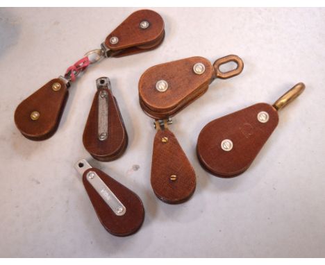 Seven vintage Teflon rigging blocks (7).