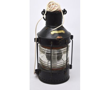 An ebonised ship's lamp with brass plaque inscribed 'Ankerlicht', converted to electricity, height approx 52cm.