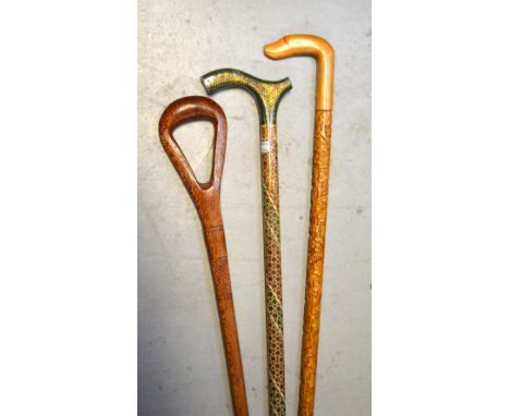 Two walking canes to include a floral-carved example, an Indian-inspired example and a shooting stick (3).