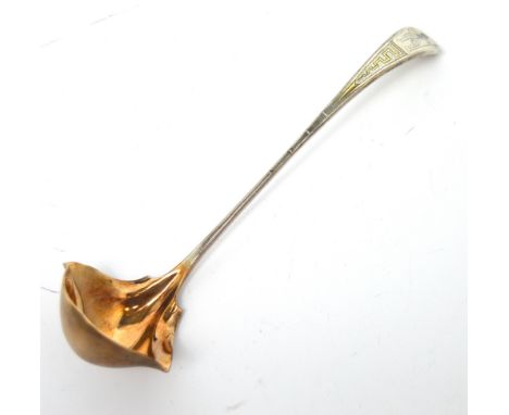 A boxed Tiffany sterling silver ladle with gilt bowl and engraved decoration of a Persian warrior, width 18cm, approx 1.5ozt.