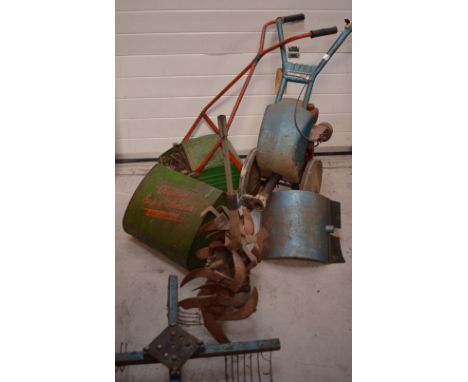 A vintage Qualcast Super Panther ballbearing green and red painted lawn mower and a vintage blue and red painted Gardenmaster