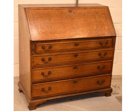 A late c1900 oak and inlaid bureau with fitted interior and four drawers, overall raised on bracket feet, width 103cm.