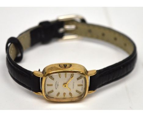 Rotary; a 9ct yellow gold ladies' quartz wristwatch, silvered dial set with gilt and ebonised batons, on leather strap.
