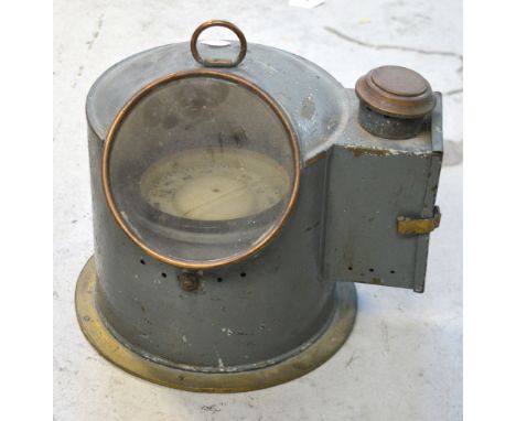 A binnacle-type compass housed within grey-painted casing, height 23cm.