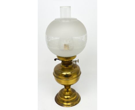 A brass oil lamp with opaque and etched glass shade, height 50cm.