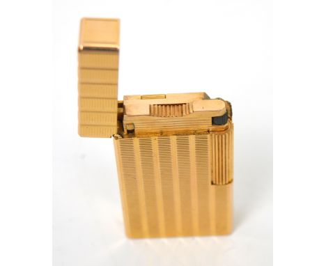 A vintage Dupont of Paris gold plated lighter with spare flints.