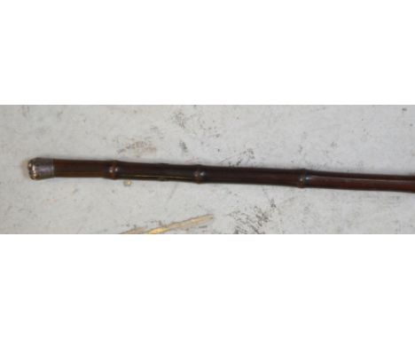 A Victorian bamboo-effect walking/swagger stick with hallmarked silver top, inscribed 'March 1873'.