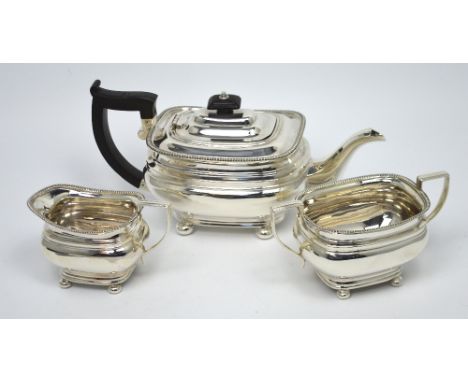 A George V hallmarked silver three-piece tea service comprising teapot, sucrier and milk jug, Sheffield 1926, combined approx