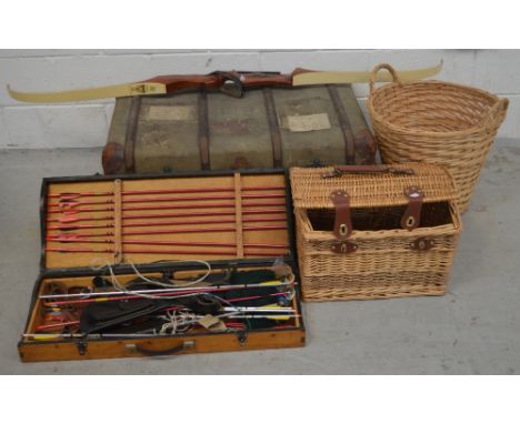 A collectors' lot comprising Les Howis Bows Ltd stag bow with boxed set of arrows, a large canvas trunk, a wicker picnic hamp
