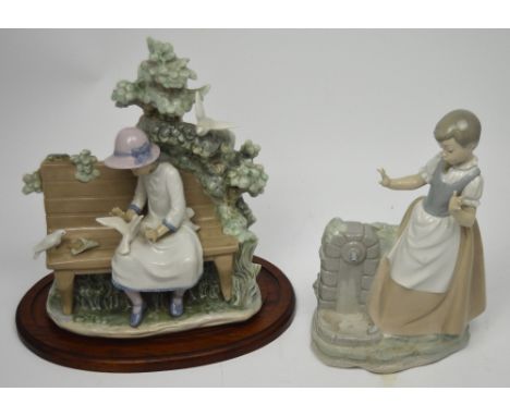 A Nao figure group, a young girl sitting on a bench surrounded by birds and foliage, width 25cm, with associated stand and a 