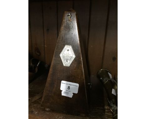 A French Maelzel Paquet metronome.After inspection the Lot 8 has a winding key. Please see the additional images for a closer