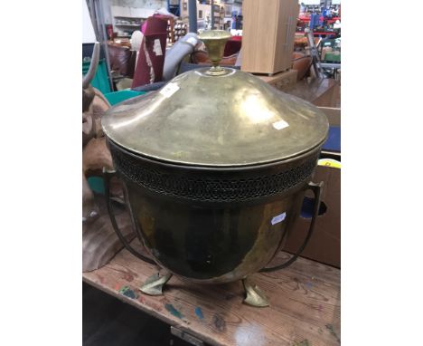 An Edwardian brass coal holder on arrow feet, with metal insert and cover.  