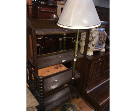 A rustic pine coffee table, a small open bookcase and an adjustable floor standing brass lamp.  