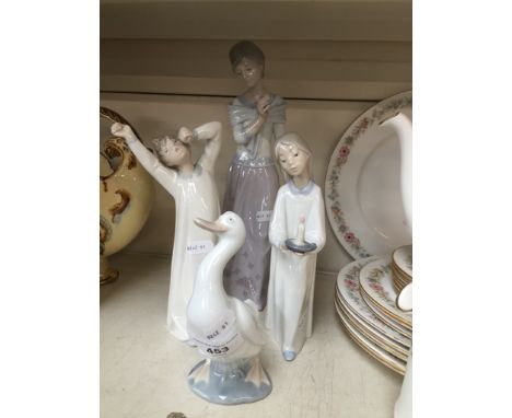 A group of three Lladro figures (choir boy head repaired at neck), and a Nao duck.  