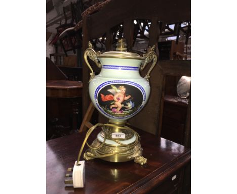 A brass mounted pottery lamp decorated with a cherub to one side and a bocquet to the other, height 34cm.Condition Report: Af