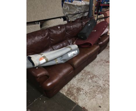 A three seat brown leather sofa and matching armchair.  